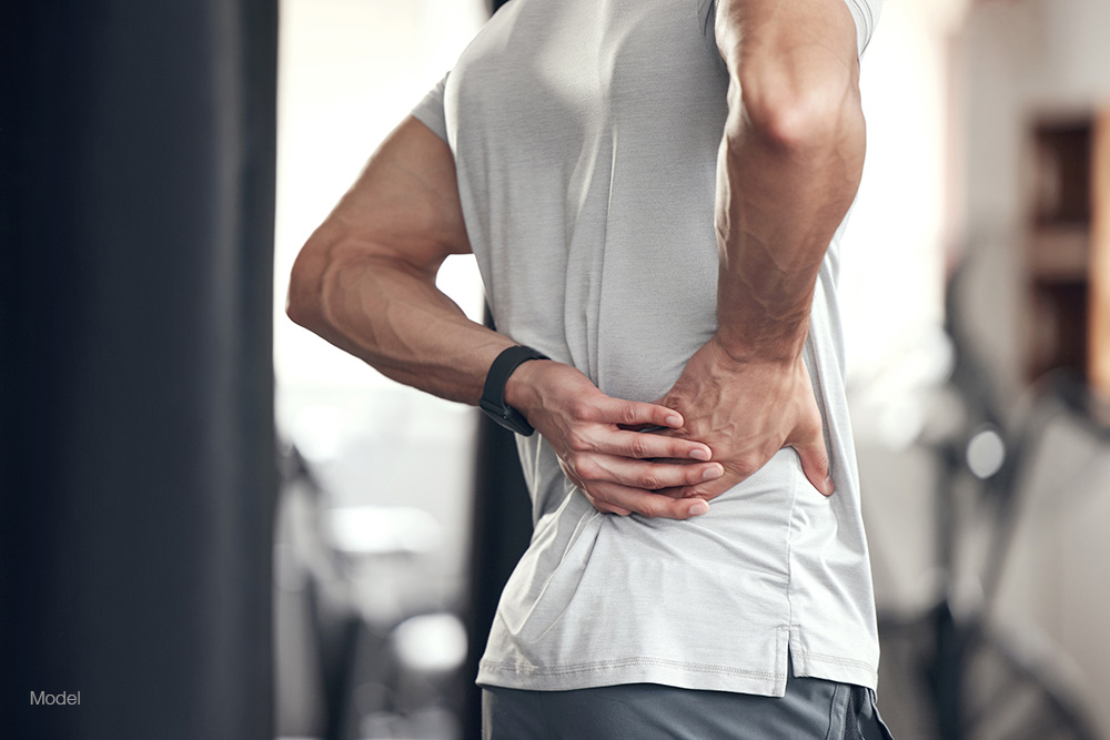 A man holding his hip in pain