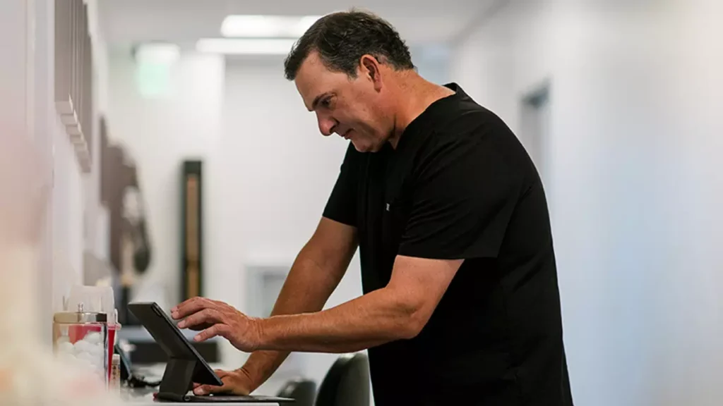 Dr. Snibbe working at a computer