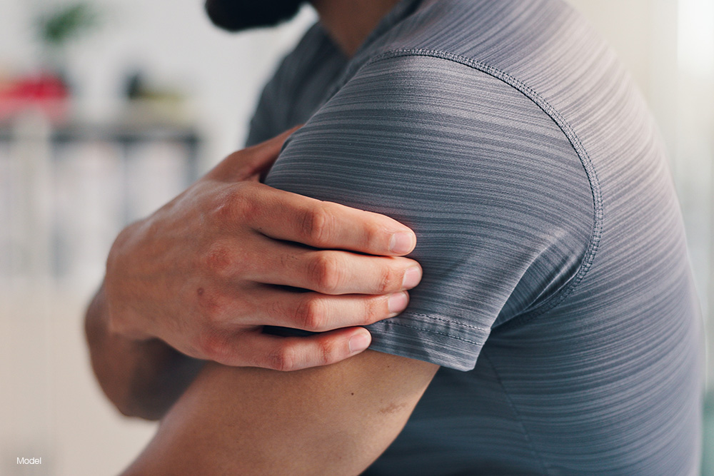 Man holding his shoulder in pain